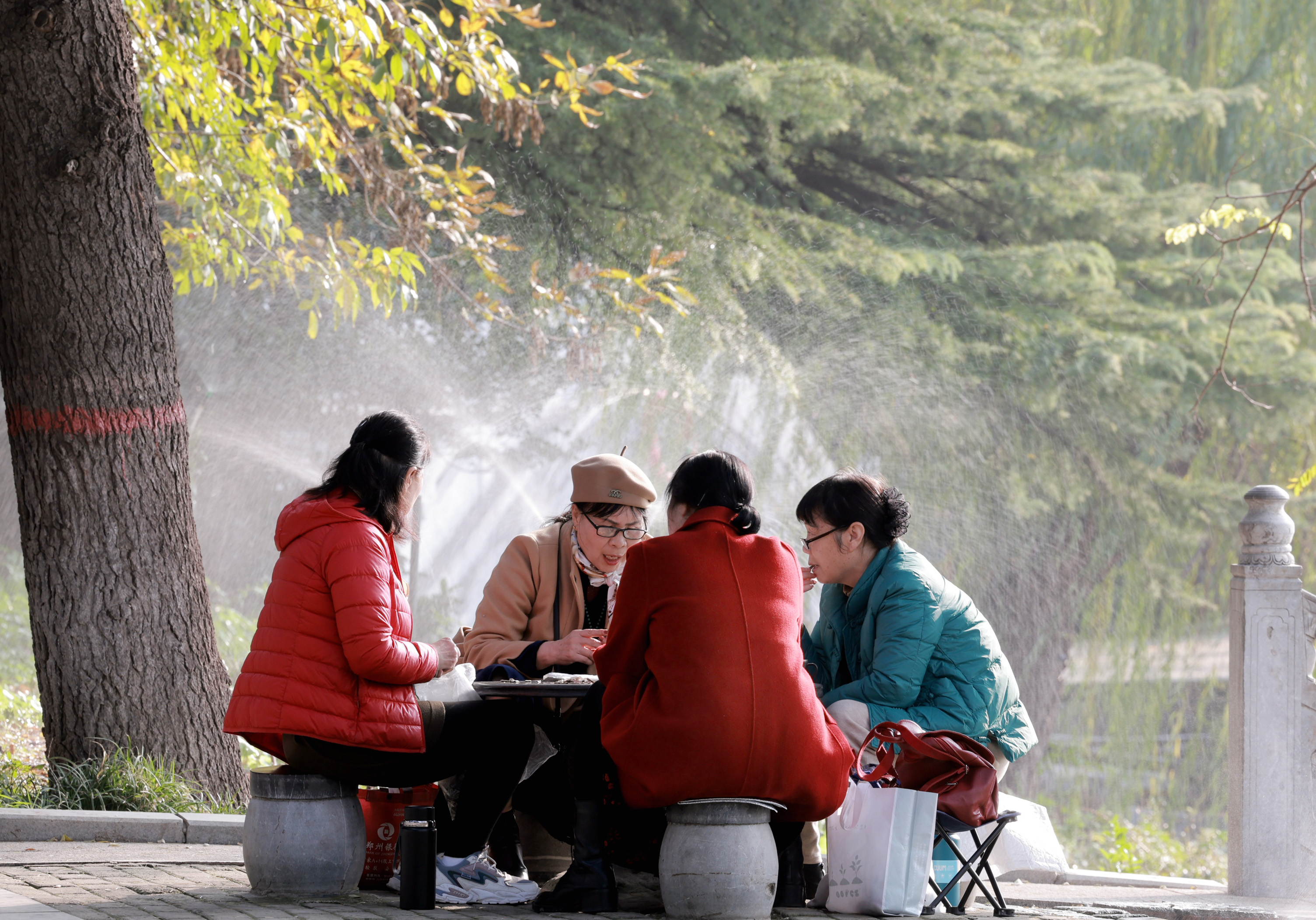 11月13日，老人们在石桌前喝茶聊天。